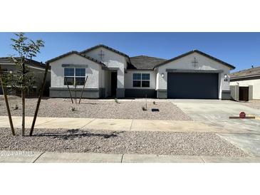 Charming single-Gathering home featuring a gray garage door, modern stucco, and low-maintenance desert landscaping at 15429 W Cottontail Ln, Surprise, AZ 85387