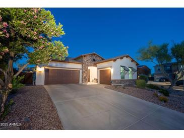 Charming single-Gathering home with a well-manicured yard, three-car garage, and stone accents at 31311 N 138Th Ave, Peoria, AZ 85383