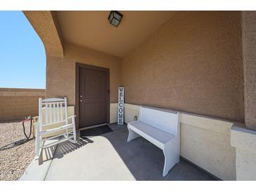 Inviting front porch with seating and a 'Welcome' sign, creating a cozy entrance at 4088 N 309Th Cir, Buckeye, AZ 85396