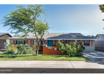 Charming single-story home with a well-maintained front yard and mature tree at 1027 E El Camino Dr, Phoenix, AZ 85020