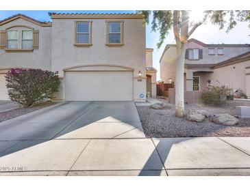 Well-maintained two-story home featuring a two-car garage and neutral stucco exterior at 13585 N 87Th Dr, Peoria, AZ 85381
