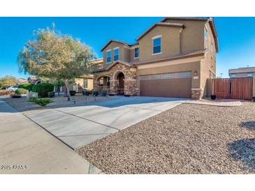 Charming two-story home with attached two-car garage and well-maintained front yard at 15105 W Glenrosa Ave, Goodyear, AZ 85395