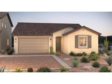 Charming single-story home with a two-car garage and desert landscaping in the front yard at 16446 W Whispering Wind Dr, Surprise, AZ 85387
