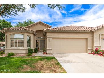 Charming single-story home with tile roof, desert landscaping, and a spacious two-car garage in a beautiful neighborhood at 23756 S Vacation Way, Sun Lakes, AZ 85248
