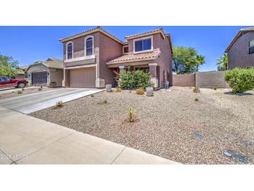 Charming two-story home featuring a low-maintenance front yard and a two-car garage at 43822 W Baker Dr, Maricopa, AZ 85138