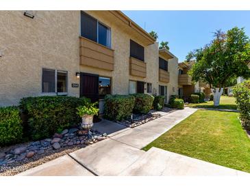 Charming townhome featuring a well-kept lawn and a cozy front entrance, perfect for a relaxed lifestyle at 4630 N 68Th St # 264, Scottsdale, AZ 85251