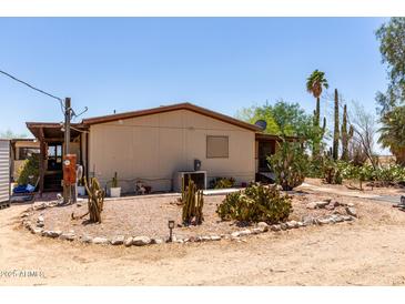 View of home exterior with desert landscaping including cacti and gravel at 49478 W Val Vista Rd, Maricopa, AZ 85139