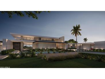 Striking modern home featuring sleek lines, a grand entrance, and lush landscaping against a twilight sky at 6525 E Bluebird Ln, Paradise Valley, AZ 85253