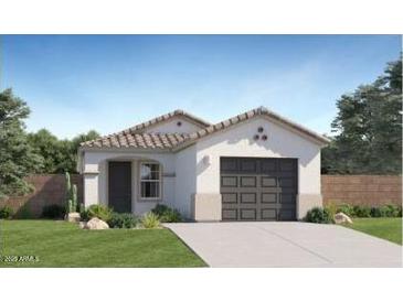 Charming single-story home featuring a tile roof, well-manicured lawn, and attached two car garage at 12039 E Primrose Ln, Florence, AZ 85132