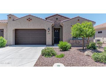 Charming home with a well-maintained landscaped front yard, a two-car garage, and a welcoming entrance at 16417 W Piccadilly Rd, Goodyear, AZ 85395