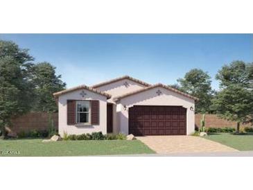 New construction home featuring a two-car garage, neutral color palette, and desert landscaping at 23334 W Mobile Ln, Buckeye, AZ 85326