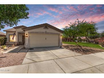 Charming single-story home with a two-car garage and well-maintained landscaping at 30259 N Sunray Dr, San Tan Valley, AZ 85143