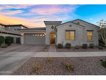 Charming single story home with a neutral colored exterior and desert landscaping at 4360 S Atom --, Mesa, AZ 85212