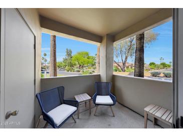 Inviting outdoor balcony featuring comfortable seating with picturesque neighborhood views at 5335 E Shea Blvd # 1087, Scottsdale, AZ 85254