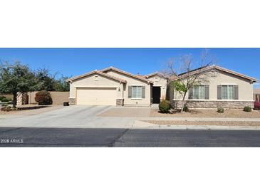 Charming single-story home with a two-car garage, desert landscaping, and a welcoming entrance at 5616 W Hidalgo Ave, Laveen, AZ 85339