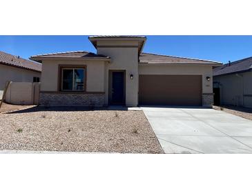 Attractive single-story home with a brown roof, low-maintenance desert landscaping, and an attached two-car garage at 7259 E Blissful Breeze Ln, San Tan Valley, AZ 85143