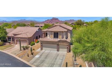 Charming two-story home showcasing desert landscaping and a three-car garage at 7260 E Tasman St, Mesa, AZ 85207