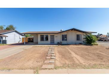 Charming single-story home with desert landscaping and covered carport at 8339 W Devonshire Ave, Phoenix, AZ 85037