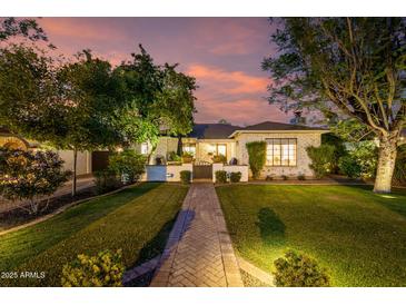 Charming single-Gathering home with mature trees, lush lawn, and brick pathway leading to the entrance at 1625 N 11Th Ave, Phoenix, AZ 85007