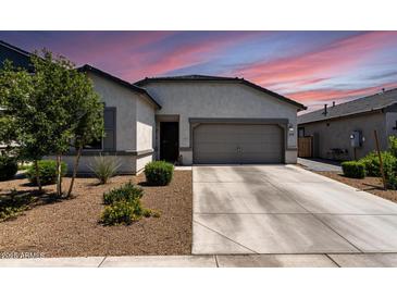 Beautiful single-story home featuring a two-car garage and landscaped front yard at 16617 W Desert Mirage Dr, Surprise, AZ 85388