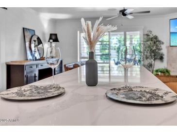 Bright kitchen featuring quartz countertop island, breakfast bar and stainless steel appliances at 3505 N Miller Rd, Scottsdale, AZ 85251