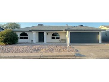 Charming single-story home featuring a well-maintained front yard and attached garage at 4151 E Clovis Ave, Mesa, AZ 85206
