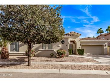 Charming single-story home boasts a meticulously landscaped yard and attached two-car garage at 4667 E Reins Rd, Gilbert, AZ 85297