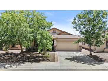 Charming single story home with a lush front yard and two car garage at 5303 W Hackamore Dr, Phoenix, AZ 85083