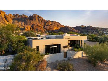 Stunning aerial view of a modern house with views of majestic mountains at 5905 N Echo Canyon Ln, Phoenix, AZ 85018
