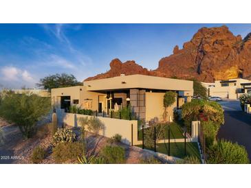Modern home exterior featuring desert landscaping and striking views of Camelback Mountain at 5905 N Echo Canyon Ln, Phoenix, AZ 85018