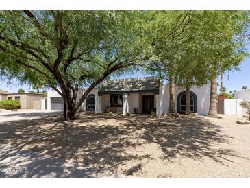 Charming single-story home featuring desert landscaping and unique architectural details at 7020 E Friess Dr, Scottsdale, AZ 85254