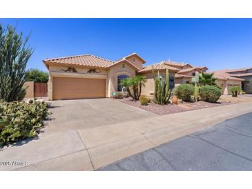 Charming single-story home featuring a desert landscape and a two-car garage at 9722 S 45Th Ave, Laveen, AZ 85339