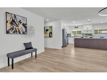 Cozy living space with decor, flowing into the beautifully renovated kitchen and offering comfortable seating at 13215 N 30Th Pl, Phoenix, AZ 85032