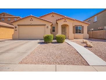 Charming single-story home with a well-maintained front yard, desert landscaping, and two-car garage at 17693 W Lincoln St, Goodyear, AZ 85338