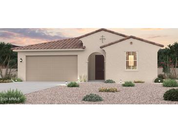 Charming single-story home featuring a well-manicured desert landscape and an attached two-car garage at 18134 W Creedance Blvd, Surprise, AZ 85387