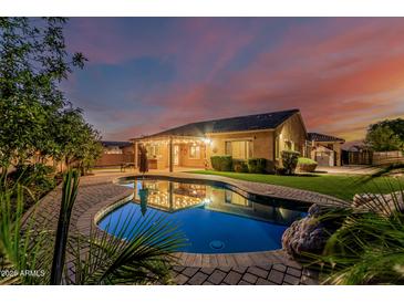 Backyard pool and patio reflecting home at dusk at 2741 E Odessa St, Mesa, AZ 85213