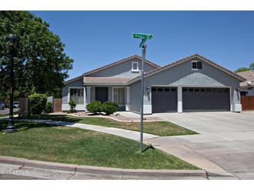 Charming single-story home featuring a well-maintained lawn, gray exterior, and a two-car garage at 3314 E Page Ave, Gilbert, AZ 85234