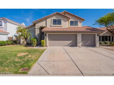 Inviting two-story home featuring a large three-car garage and well-maintained landscaping at 3837 E Windsong Dr, Phoenix, AZ 85048
