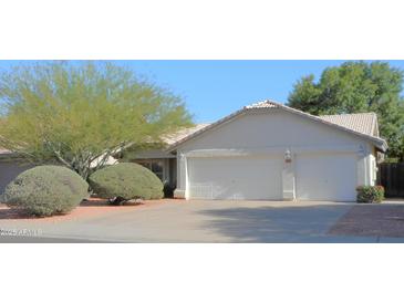 Charming home with a three-car garage, mature trees and low maintenance landscaping at 4513 E Grovers Ave, Phoenix, AZ 85032