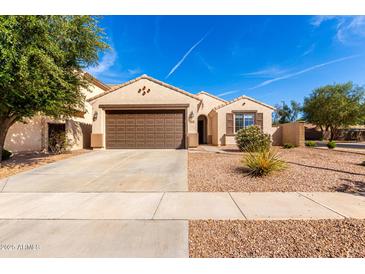 Charming single-story home with a brown two car garage, desert landscaping and a walkway to the front door at 4639 E Cabrillo Dr, Gilbert, AZ 85297