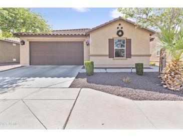 Charming single-story home with a two-car garage and low-maintenance desert landscaping at 7575 W Darrel Rd, Laveen, AZ 85339