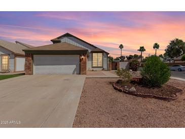 Charming single-story home with a two-car garage and well-manicured desert landscaping at 830 E Gila Ln, Chandler, AZ 85225