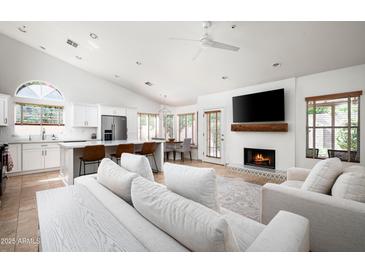 Open-concept living area with fireplace, lots of light, and a seamless flow to the kitchen at 8896 E Mescal St, Scottsdale, AZ 85260