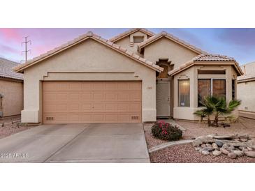 Charming single-story home with a two-car garage and beautiful desert landscaping at 1060 W Dava Dr, Tempe, AZ 85283