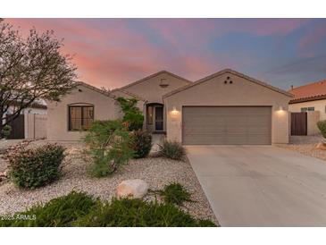 Charming home featuring desert landscaping, neutral stucco, and a two-car garage, perfect for low-maintenance living at 17562 W Desert Sage Dr, Goodyear, AZ 85338