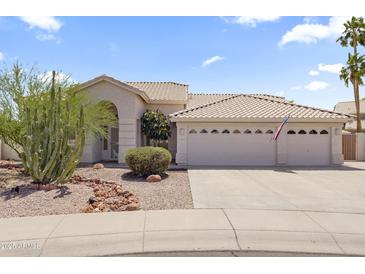Charming home exterior featuring well-maintained landscaping and a spacious three-car garage at 19010 N 35Th Way, Phoenix, AZ 85050