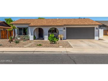 Charming single-story home with a well-maintained yard and attached two-car garage at 2444 S Noche De Paz --, Mesa, AZ 85202