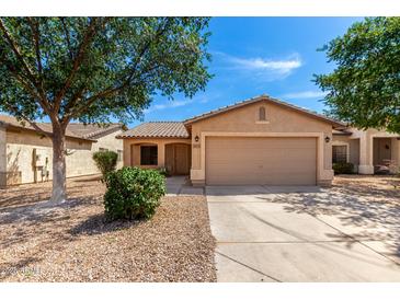 Charming single-story home featuring a two-car garage and low-maintenance desert landscaping at 30212 N Sunray Dr, San Tan Valley, AZ 85143