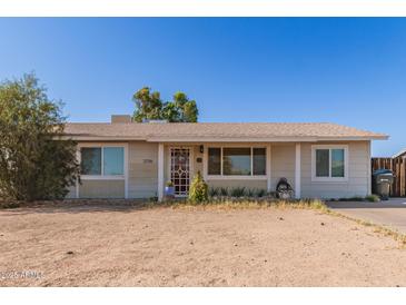 Charming single-story home with desert landscaping, featuring a cozy front entrance and ample natural light at 3256 W Libby St, Phoenix, AZ 85053