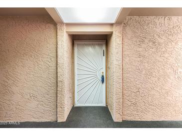 Inviting front door with unique sunburst design and neutral surroundings creates a welcoming entrance at 540 N May -- # 3117, Mesa, AZ 85201